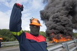 Un traballador de Alcoa San Cibrao levanta o puño durante unha manifestación na que cortaron a Autoestrada A6 coa queima de pneumáticos, en Outeiro de Rei, Lugo, Galicia (España), a 22 de setembro de 2020.. Carlos Castro - Europa Press