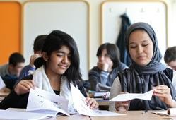 Dúas nenas migrantes estudando na clase / Unicef - Arquivo